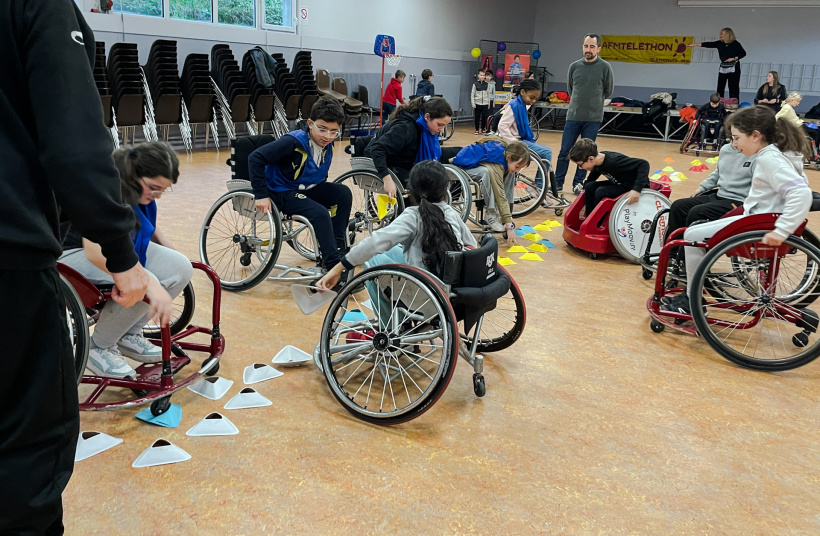 Les élèves en pleine partie de jeu en basket fauteuil